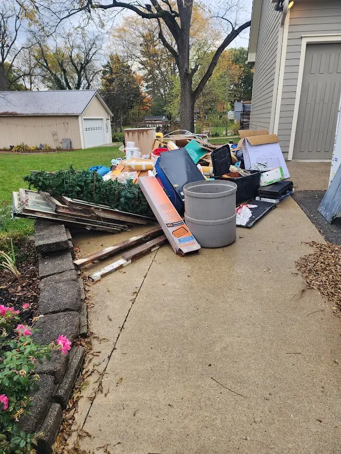 Dumpster being loaded with debris for Estate Cleanout Dumpster Rental in Whiteriver